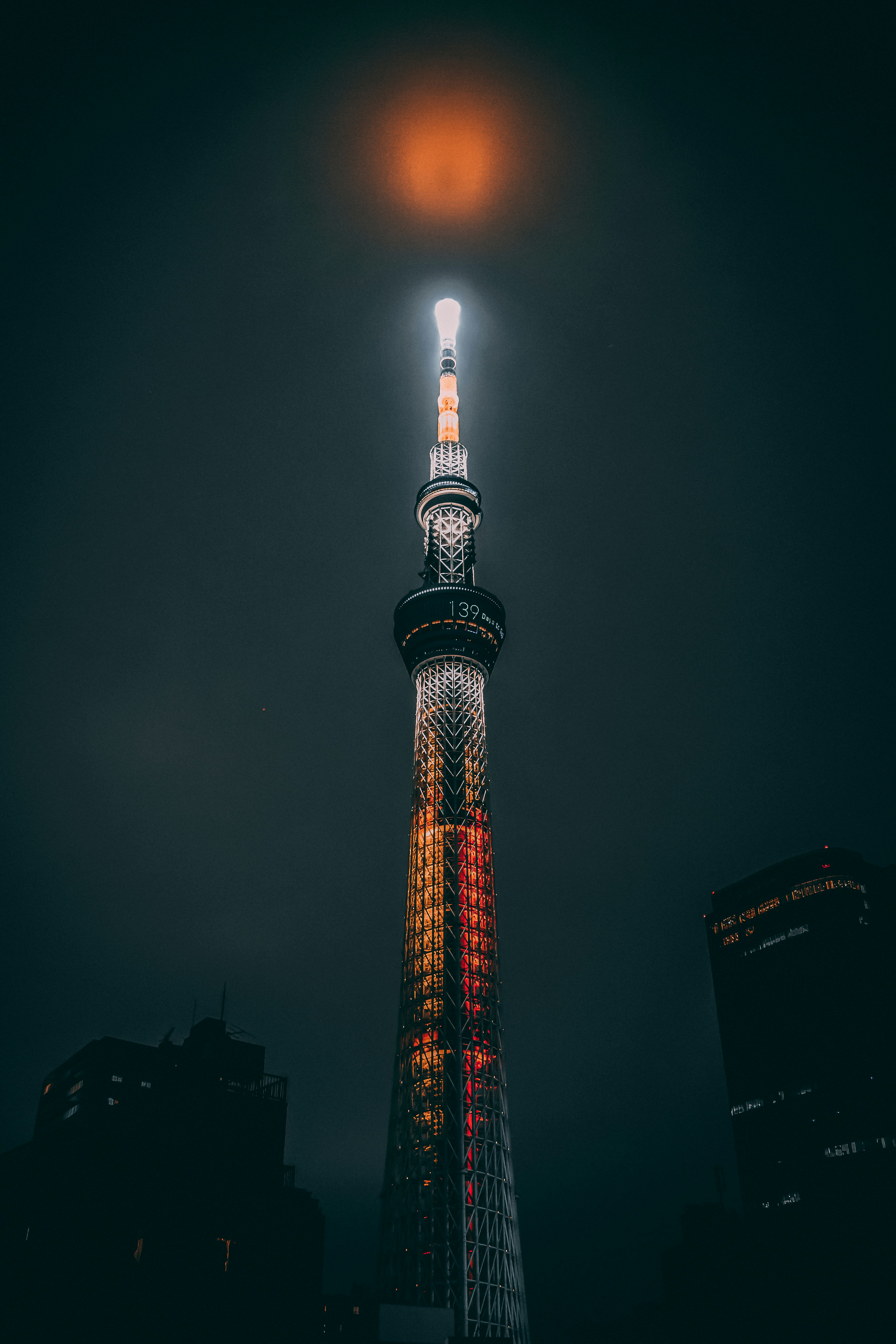 red and white tower during night time